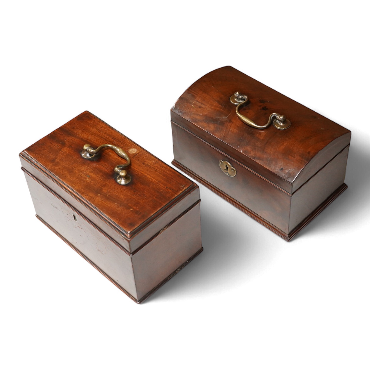 A George III mahogany dome-top tea caddy, together with another, 23cm wide